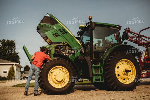 Farmer Checking Tractor Oil 4454