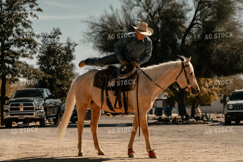 Rancher Getting on Horse 58234