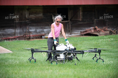 Female Pilot Preparing Drone for Fungicide Application 168070