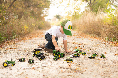 Farm Kid Playing with Toy Tractors 185073