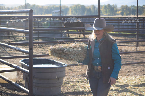 Female Rancher Feeding Horse 117085