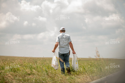 Rancher Giving Mineral to Cattle 212056