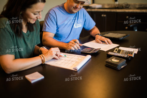 Husband and Wife Farmers Going Over Paperwork 6183