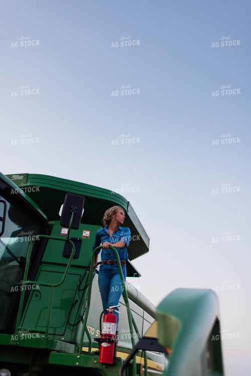 Female Farmer Climbing into Combine 8401