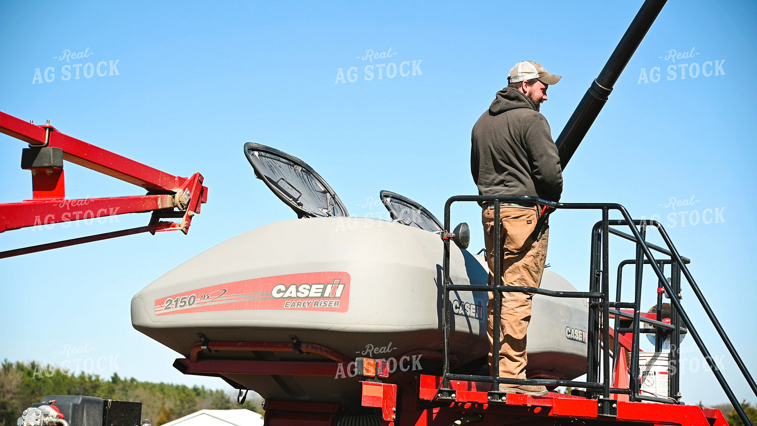 Farmer Loading the Planter with the Seed Tender 25098