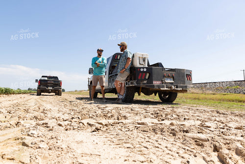 Farmers Leaning on Truck Talking 79677