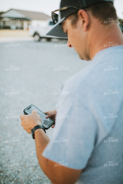 Farmer Looking at Phone 6256