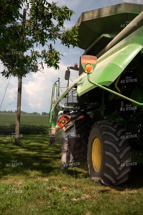 Farmer Cleaning Combine 115830