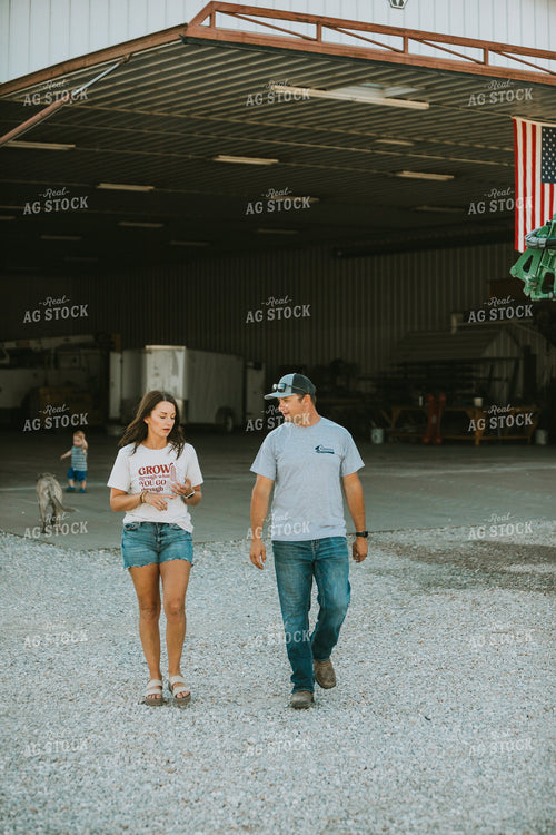 Farmer and Farm Wife Talking Outside Shop 6243
