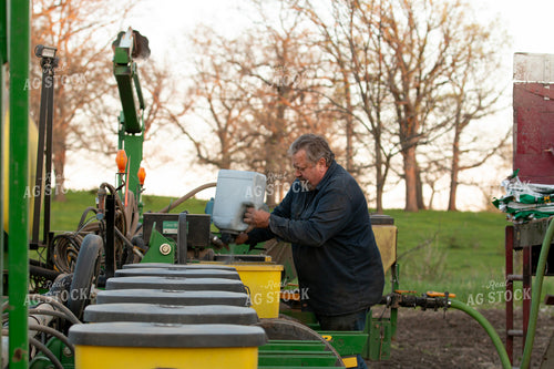 Farmer Adding Seed Lubricant to Planter Box 157309