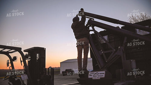 Farmer Loading the Seed Tender with a Skidsteer 25210