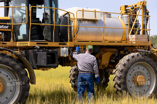 Farmer Adjusting Controls on Self Propelled Sprayer 52622
