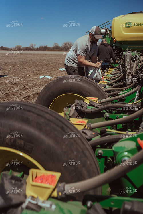 Farmer Filling Planter for Test Plot 196124