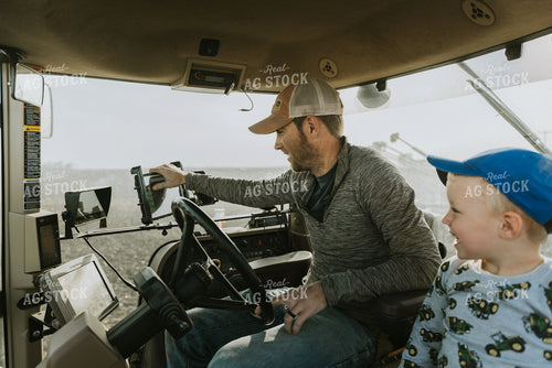 Farmer in Tractor Cab with Son 8183