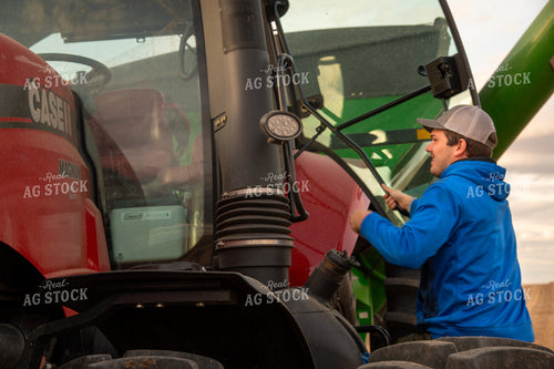 Farmer Climbing into Tractor Cab 25685