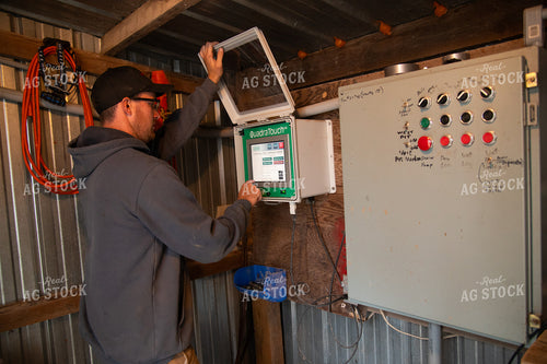 Farmer Adjusting Dryer Settings 25547