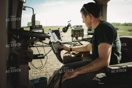 Farmer Adjusting Planter Monitor 4114