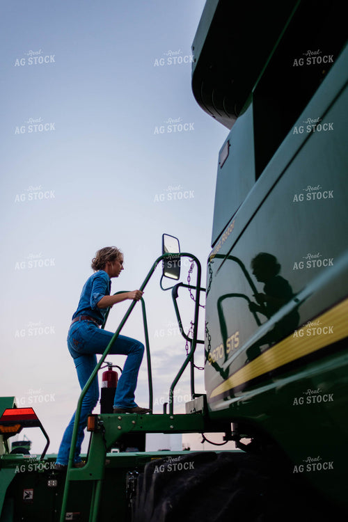 Female Farmer Climbing into Combine 8399
