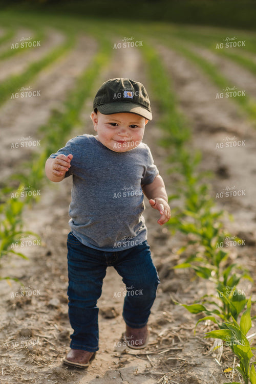 Farm Kid Running in Early Growth Corn Field 115055