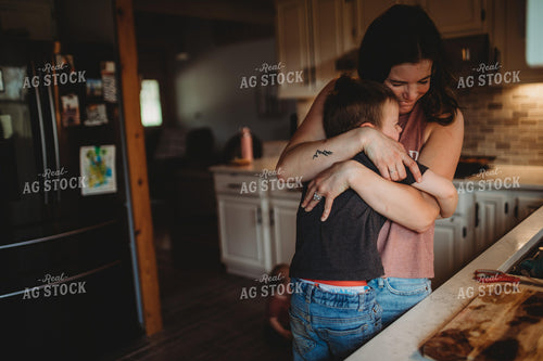 Farm Mom and Farm Kid Hugging in Kitchen 5590
