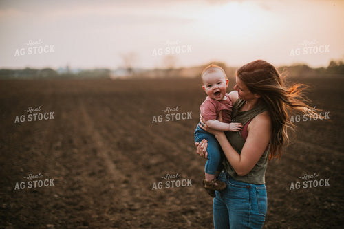Farm Mom with Farm Kid in Field During Planting 5705