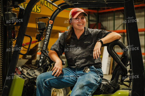 Female Farmer Driving Skid Steer 115237
