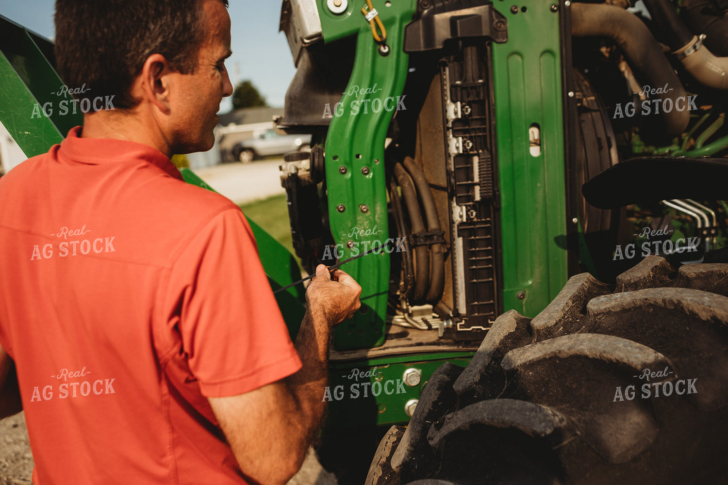 Farmer Checking Tractor Oil 4456