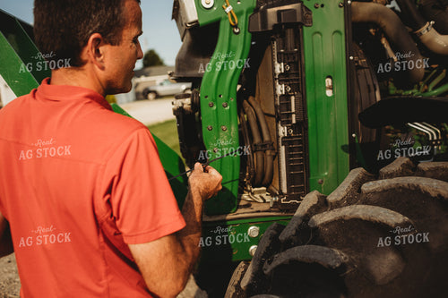Farmer Checking Tractor Oil 4456