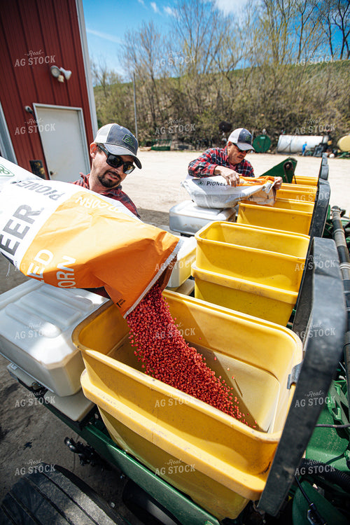 Farmer Filling Planter with Seed Bag 250159