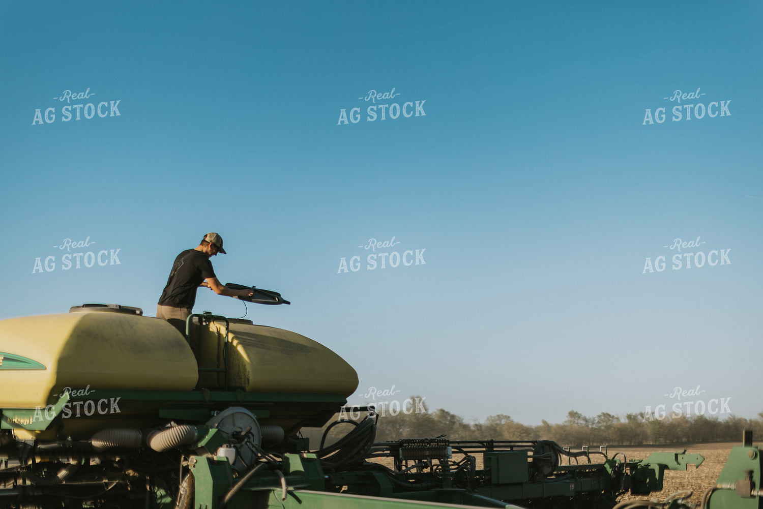 Young Farmer Prepares to Fill Planter 7654
