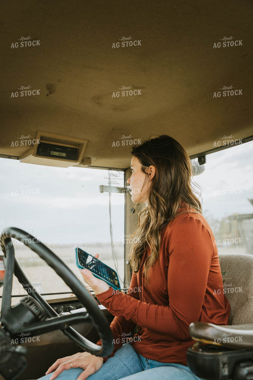 Female Farmer Using Phone in Tractor 8546