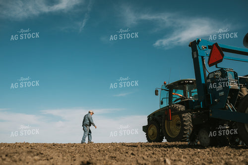 Farmer Climbing out of Tractor with Planter 4100