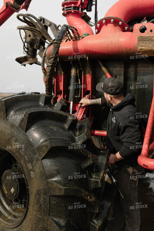 Farmer Greasing Manure Crawler 152699