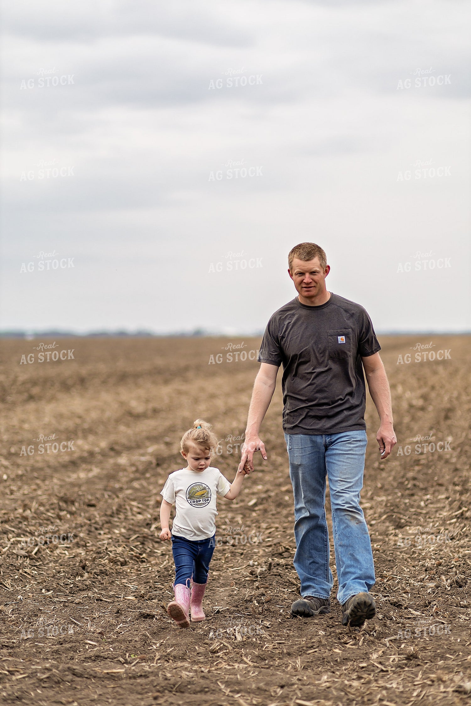 Farmer and Daughter Walking in Field 93315