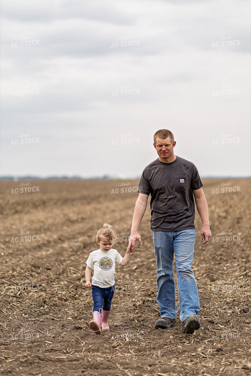 Farmer and Daughter Walking in Field 93315