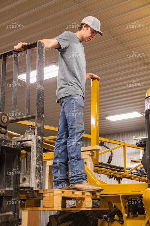 Farmer Fixing Self-Propelled Sprayer 231125