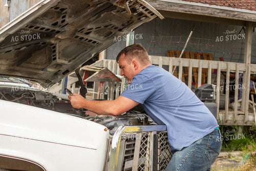 Farmer Repairing Truck Engine 155194