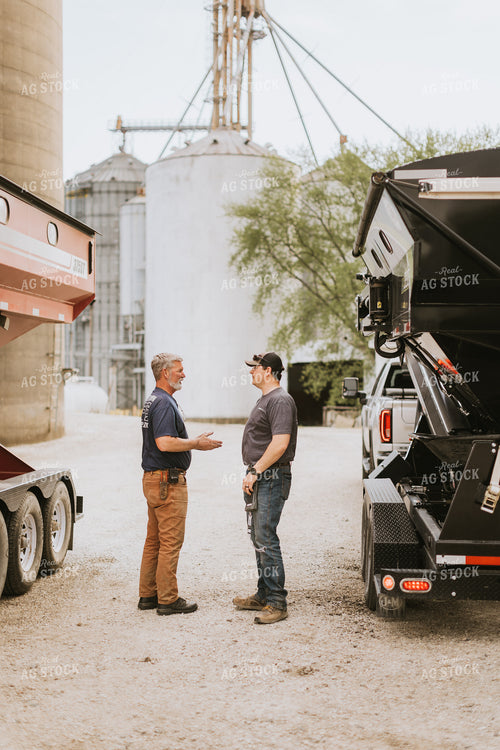Farmers Talk in Front of Grain Bins 7594