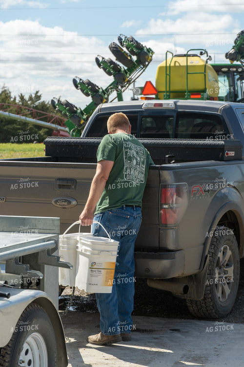 Farmer Holding Talc Buckets 65408