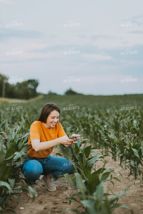 Female Farmer Takes Picture of Corn Plant 7841