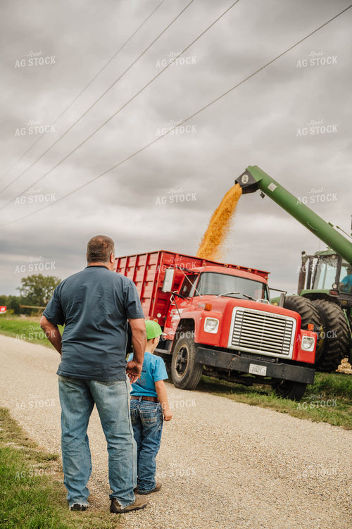 Farm Kid and Dad Working in the Field 115345