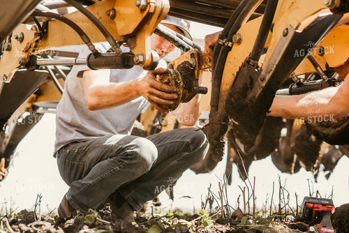 Farmer Working on Planter 64257