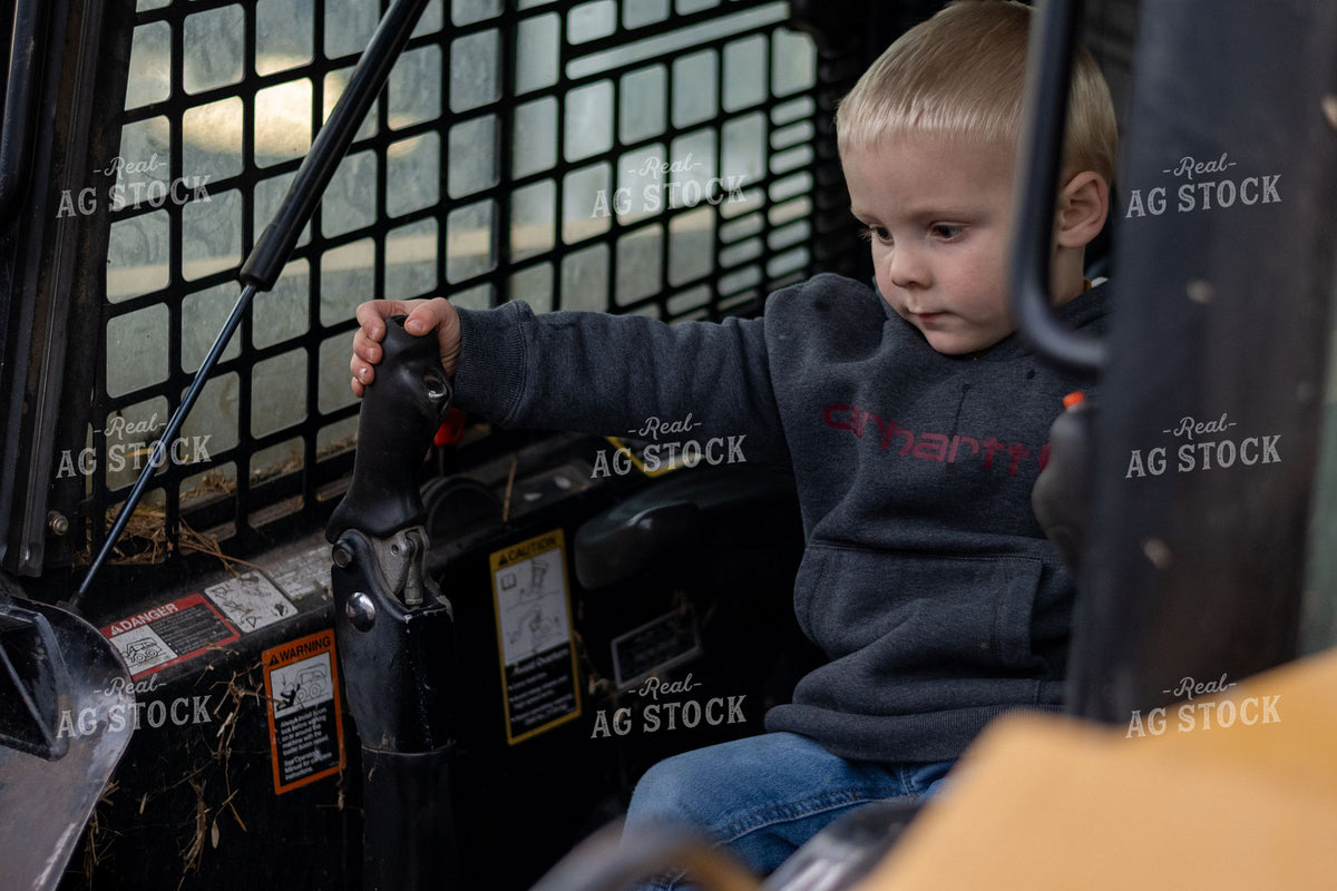 Young Farm Boy Exploring Skid Steer Controls 418003