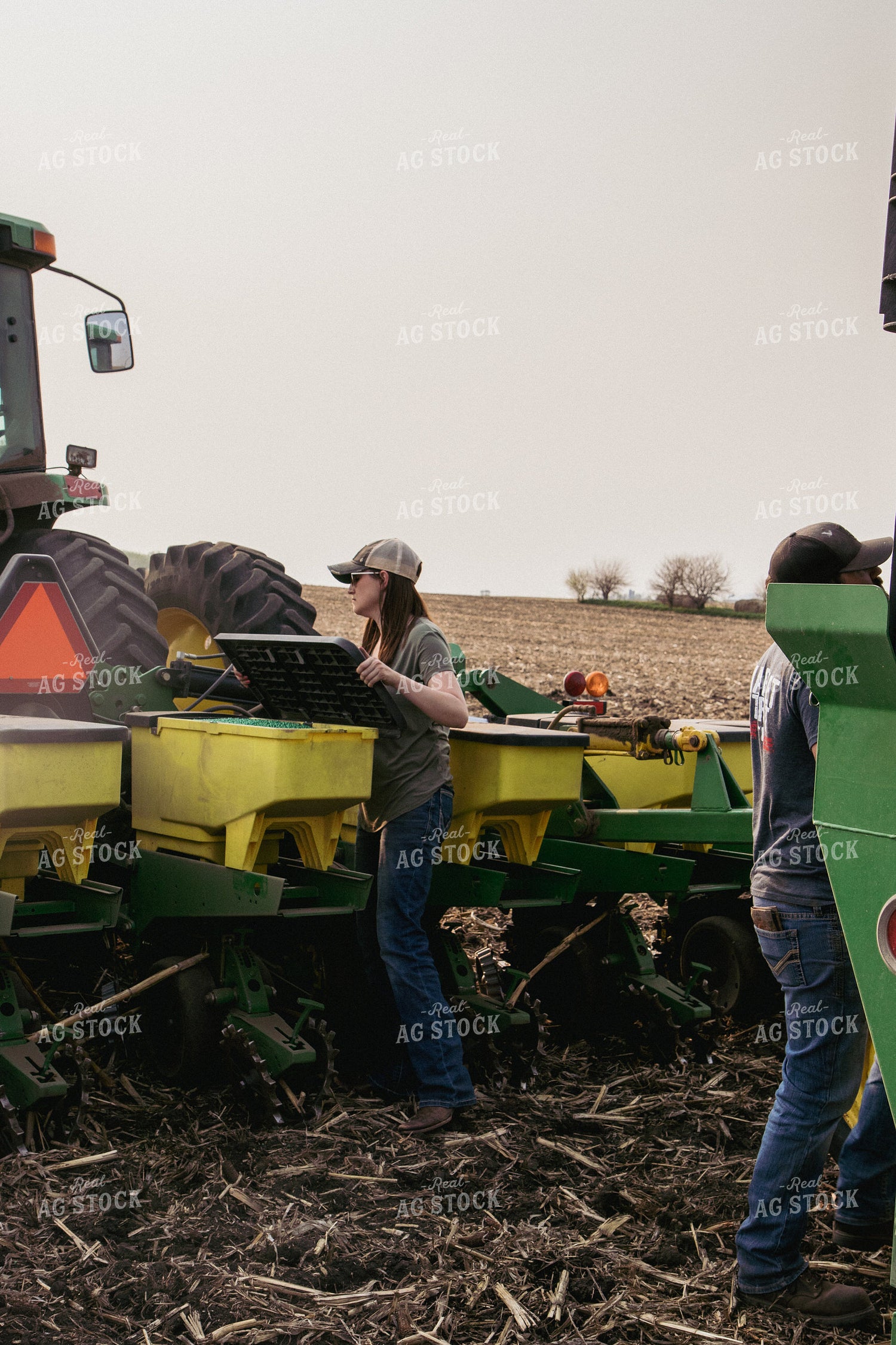 Female Farmer Loading Planter Boxes with Seed 67316