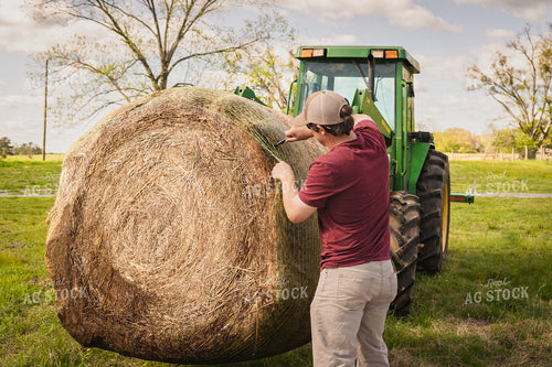 Farmer Unwrapping Hay Bales 128015