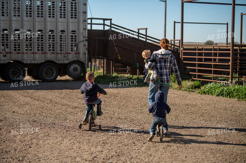 Female Rancher Walking with Farm Kids 212088