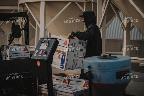 Farmer Moves Seed Treatment Boxes 135011