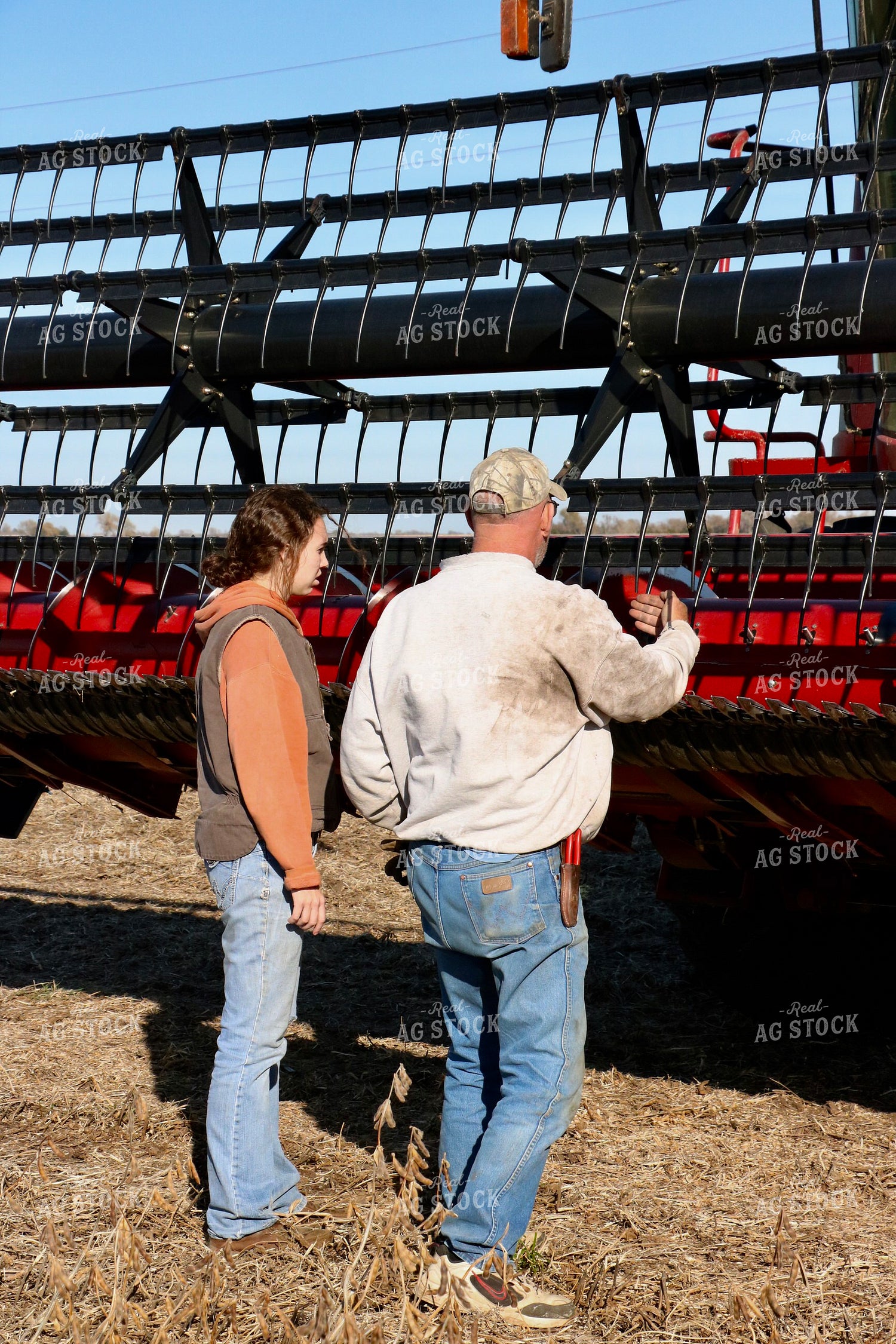 Farmer and Farm Kid Working on Combine 299280