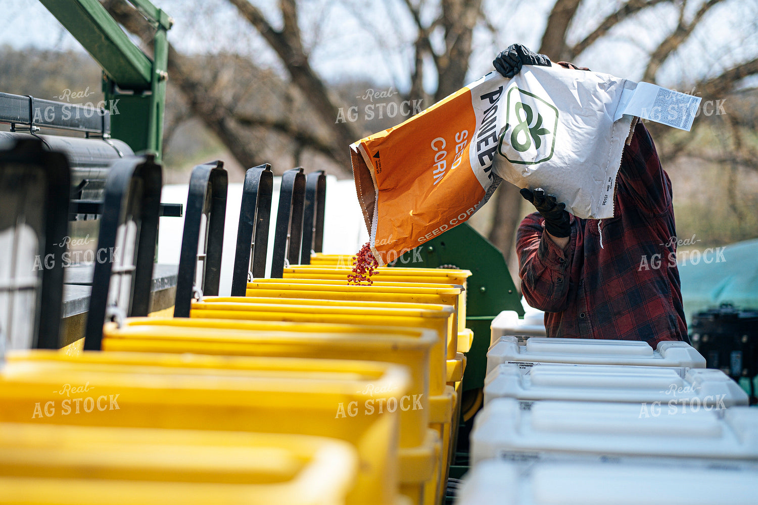 Farmer Filling Planter with Seed Bag 250157