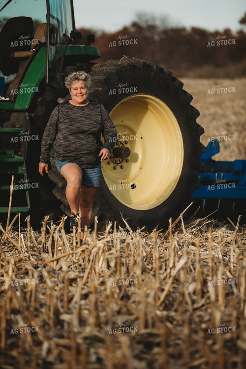 Female Farmer Getting out of Tractor with Disk 3623